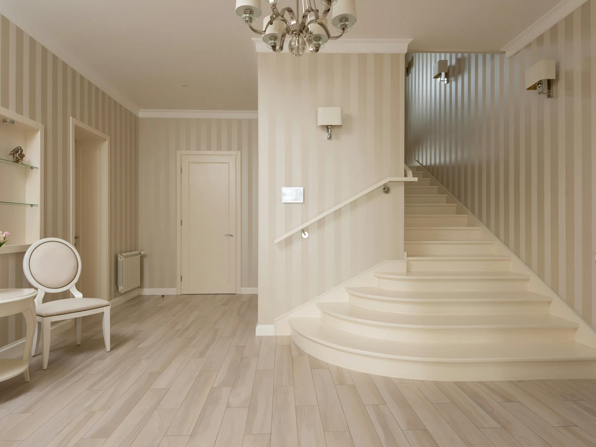 Bedroom with floral wallpaper feature wall, painted by Cambridge Decorators