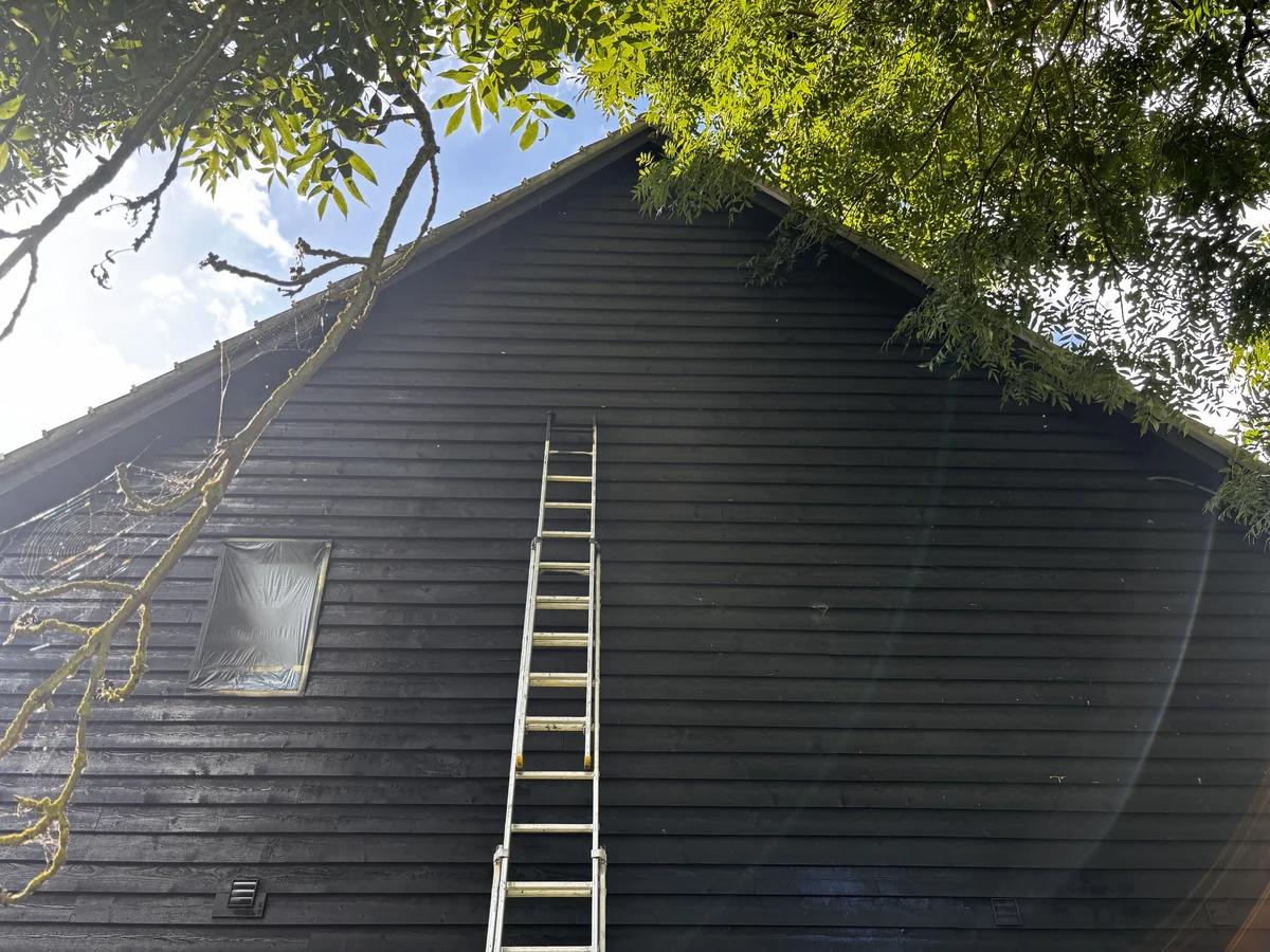 Wood painting in Cambridge — black cladding gable end — Cambridge Decorators