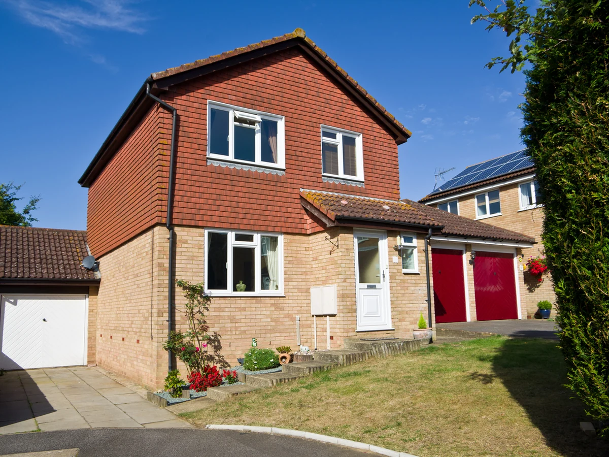 Exterior painting on detached red brick property in Cambridge by Cambridge Decorators