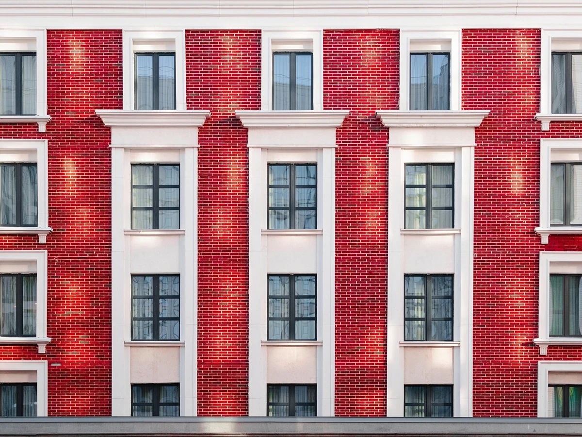 Exterior painting on red brick building in Cambridge by Cambridge Decorators