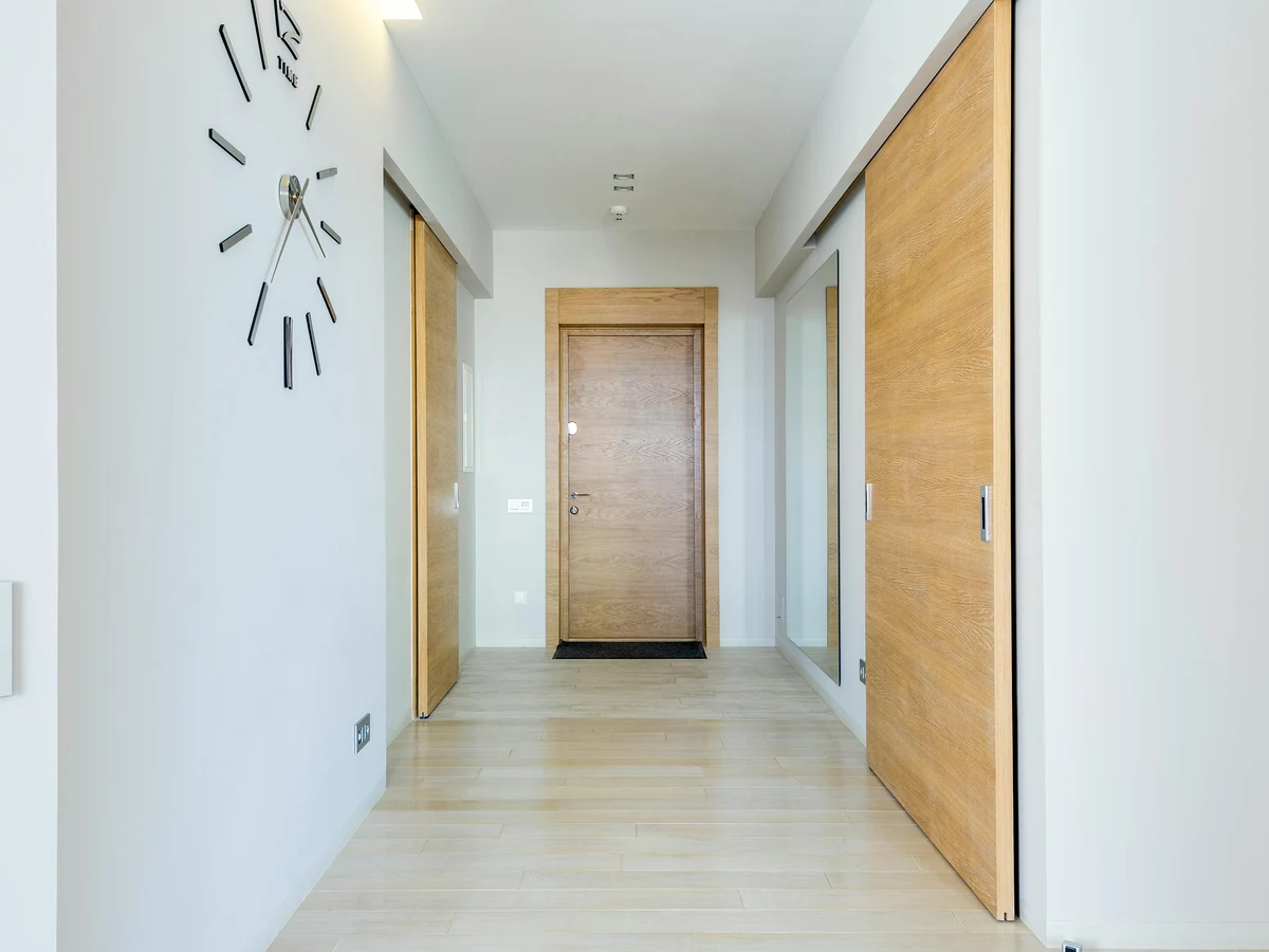 hallway-painting-white-hallway-wood-cambridge-decorators White hallway with wood floor and painted doors by Cambridge Decorators