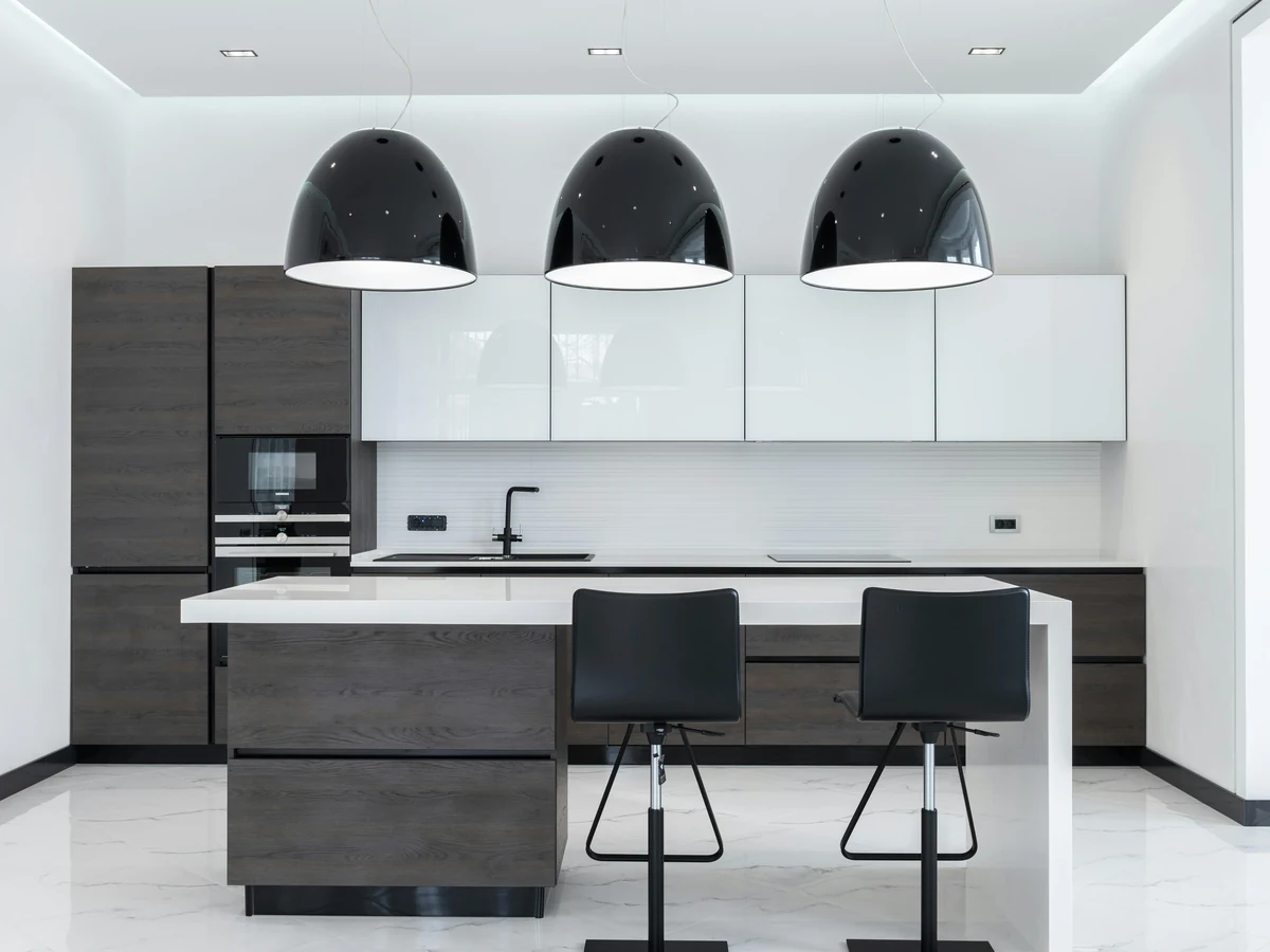 Monochrome modern kitchen with painted cabinets in Cambridge by Cambridge Decorators