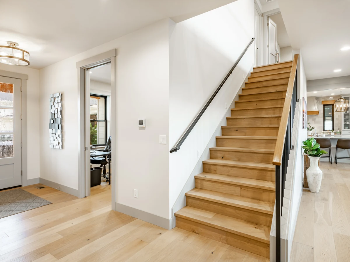 Bright farmhouse hallway staircase painted by Cambridge Decorators