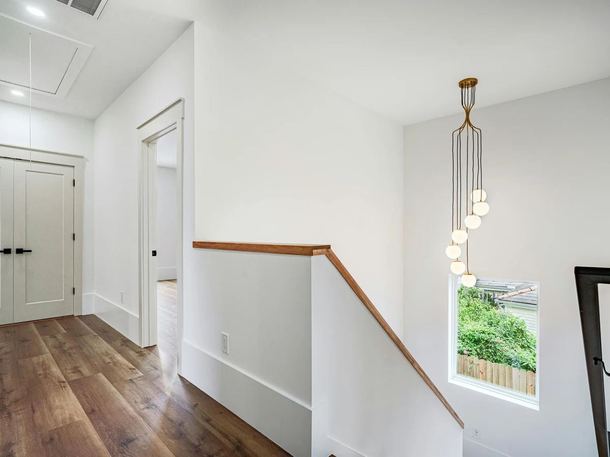 Modern white landing staircase painted by Cambridge Decorators