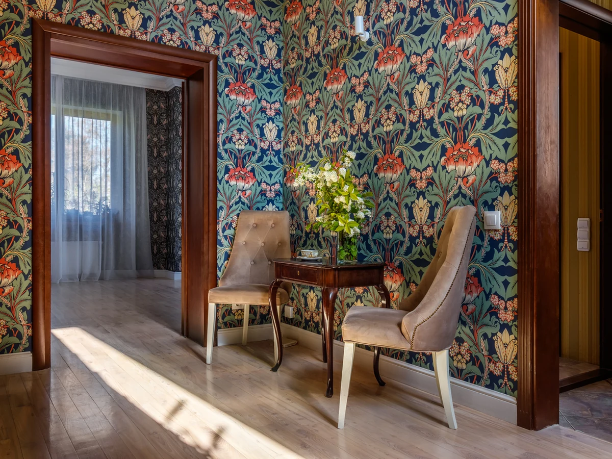 Ornate floral wallpaper hung by Cambridge Decorators, detailed pattern-matched installation