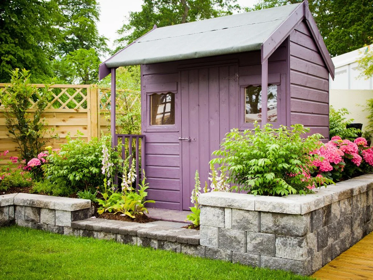Purple painted wooden garden structure in Cambridge by Cambridge Decorators